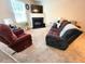 Carpeted living room featuring a fireplace, TV, sofa, and chair at 5126 Thornton Knoll Way, Raleigh, NC 27616