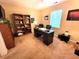 Well-lit office space with desk, chair, bookcase, and a large window for natural light at 5126 Thornton Knoll Way, Raleigh, NC 27616