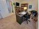 Office features a desk, rolling chair, and shelves for storage, bathed in natural light at 5126 Thornton Knoll Way, Raleigh, NC 27616