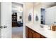 Bathroom with wood cabinets, white sink, and open view to a room beyond at 513 Dragby Ln, Raleigh, NC 27603