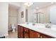 Well-lit bathroom featuring double sinks, spacious countertop and a glass-enclosed shower at 513 Dragby Ln, Raleigh, NC 27603