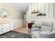 Charming Bedroom features striped wallpaper, neutral furniture, and plush armchair at 513 Dragby Ln, Raleigh, NC 27603