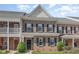 Charming brick townhome featuring a classic design and well-maintained landscaping at 513 Dragby Ln, Raleigh, NC 27603