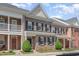 Charming brick townhome featuring a classic design and well-maintained landscaping at 513 Dragby Ln, Raleigh, NC 27603