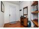 Inviting foyer with wood floors, decorated shelves, and neutral colors at 513 Dragby Ln, Raleigh, NC 27603