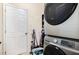 Practical laundry area featuring stacked washer and dryer with easy access to storage and exterior door at 513 Dragby Ln, Raleigh, NC 27603