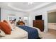 Bright main bedroom featuring a tray ceiling, desk area, and an adjoining bath at 513 Dragby Ln, Raleigh, NC 27603