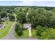Aerial view of a charming home with a well-maintained lawn and mature trees at 5801 Hadrian Dr, Durham, NC 27703