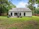 Back of the house showing the patio, grill, dining set, and fenced backyard at 5801 Hadrian Dr, Durham, NC 27703
