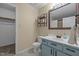 Bathroom with tile floors, blue vanity, mirror, and toilet at 5801 Hadrian Dr, Durham, NC 27703