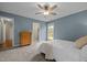 Bedroom with carpet, and a view into the attached bathroom and the backyard at 5801 Hadrian Dr, Durham, NC 27703