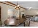 Cozy dining area with an inviting chandelier, wooden table set and easy access to the living room and kitchen at 5801 Hadrian Dr, Durham, NC 27703