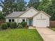 Charming single-story home with well-maintained lawn, mature landscaping, and an attached one car garage at 5801 Hadrian Dr, Durham, NC 27703