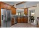 Well-equipped kitchen featuring wood cabinets, stainless steel appliances, black countertops, and lots of natural light at 5801 Hadrian Dr, Durham, NC 27703