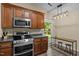 Well-lit kitchen with stainless steel appliances, wooden cabinets, and a breakfast bar at 5801 Hadrian Dr, Durham, NC 27703