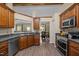 Spacious kitchen with wood cabinets, stainless steel appliances, dark countertops, and open access to the dining area at 5801 Hadrian Dr, Durham, NC 27703