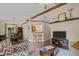Inviting living room with vaulted ceilings, wood beams, stylish furniture, and an open view to the dining area at 5801 Hadrian Dr, Durham, NC 27703