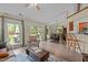 Bright, open-concept living area featuring wood floors, large windows and sliding glass doors to the backyard at 5801 Hadrian Dr, Durham, NC 27703