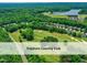 Stunning aerial view showcasing the Treyburn Country Club, surrounding homes, golf course, and water features at 603 Red Cedar Cir, Durham, NC 27712
