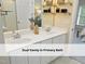 Primary bathroom featuring a dual vanity, wall mirror, and decorative shelving at 603 Red Cedar Cir, Durham, NC 27712