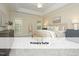 Inviting primary bedroom with tray ceilings, neutral decor, and abundant natural light at 603 Red Cedar Cir, Durham, NC 27712