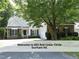 Well-maintained home with lush landscaping, mature trees, and a long driveway at 603 Red Cedar Cir, Durham, NC 27712