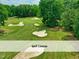 Aerial view of the well-manicured golf course featuring multiple sand traps and lush green fairways at 603 Red Cedar Cir, Durham, NC 27712
