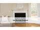 Cozy living room featuring a gas burning fireplace with decorative mantle and light-filled windows at 603 Red Cedar Cir, Durham, NC 27712