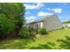 A well-maintained backyard with lush greenery, a black fence, and the home's exterior in a residential setting at 610 Mixboro Dr, Cary, NC 27519