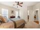Cozy bedroom with ceiling fan, dresser and comfortable bed at 610 Mixboro Dr, Cary, NC 27519