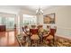 Elegant dining room with hardwood floors, chandelier and adjacent to the living room at 610 Mixboro Dr, Cary, NC 27519