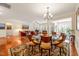 Elegant dining area with hardwood floors, a chandelier, and a view to the living room at 610 Mixboro Dr, Cary, NC 27519