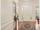 Elegant foyer with hardwood floors, a decorative rug, and a view of the front door at 610 Mixboro Dr, Cary, NC 27519