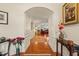 Hallway with hardwood floors leading to the living room, featuring elegant trim and decor at 610 Mixboro Dr, Cary, NC 27519