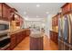 Spacious kitchen with center island, wood floors, and modern stainless steel appliances at 610 Mixboro Dr, Cary, NC 27519