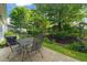 Outdoor patio with table and chairs, surrounded by lush landscaping at 610 Mixboro Dr, Cary, NC 27519
