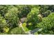 Aerial view of the home situated among mature trees, landscaping, and quiet street at 6129 Krandon Dr, Raleigh, NC 27603