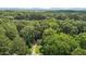 Aerial view of the home situated among mature trees and professional landscaping at 6129 Krandon Dr, Raleigh, NC 27603