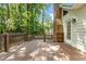 Spacious wooden back deck and brick chimney offer outdoor living and wooded views at 6129 Krandon Dr, Raleigh, NC 27603
