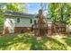 Backyard featuring a two level wooden deck, brick foundation and well manicured lawn at 6129 Krandon Dr, Raleigh, NC 27603