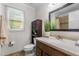 Bathroom features a single sink vanity, toilet, built-in cabinet, and a window providing natural light at 6129 Krandon Dr, Raleigh, NC 27603