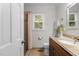 Bright bathroom features a granite countertop, tiled floor, and shower-tub combo with natural light at 6129 Krandon Dr, Raleigh, NC 27603