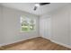 This bedroom features beautiful laminate flooring, white walls, ceiling fan and a large closet at 6129 Krandon Dr, Raleigh, NC 27603