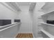 Spacious walk-in closet with white shelving and ample storage space at 6129 Krandon Dr, Raleigh, NC 27603