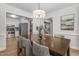 Bright dining room featuring a wood table with seating for six and modern decor at 6129 Krandon Dr, Raleigh, NC 27603
