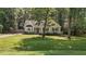 View of the home showing the well-maintained front yard and mature trees at 6129 Krandon Dr, Raleigh, NC 27603