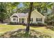 Exterior view showcasing the home's curb appeal with lush front yard at 6129 Krandon Dr, Raleigh, NC 27603