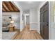 Open hallway featuring hardwood floors, neutral paint, and transitional furnishings at 6129 Krandon Dr, Raleigh, NC 27603