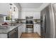 Well-lit kitchen with stainless steel appliances, granite countertops, and white cabinetry at 6129 Krandon Dr, Raleigh, NC 27603