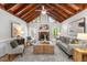 Cozy living room with exposed-beam vaulted ceiling and brick fireplace at 6129 Krandon Dr, Raleigh, NC 27603
